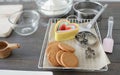Selective focus on round gingerbread cookies are baked on baking paper in tray with various shapes of molds on table Royalty Free Stock Photo