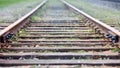 Selective focus rounding of railway abandoned rusty, overgrown with grass and moss. Empty turning single track of Royalty Free Stock Photo