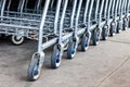 Selective focus on row of shopping carts at supermarket entrance Royalty Free Stock Photo