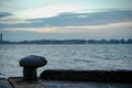 Selective focus of rusted steel post for seizing the ship at the pier