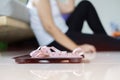 Selective focus at scale and measure tape, sad woman sitting on floor holding head and arms on knees Royalty Free Stock Photo