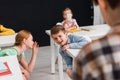 Selective focus of schoolkids gossiping while Royalty Free Stock Photo