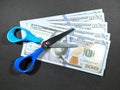 Selective focus.Scissors and money on a black background.Salary cut cost concept. Royalty Free Stock Photo