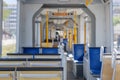 Selective focus at seat and interior view of a corridor inside passenger trains or light rail tram. Royalty Free Stock Photo