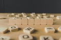 Focus of seven blank cubes surrounded by blocks with letters on wooden surface isolated on black