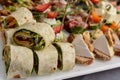 Several pieces healthy fresh chicken and salad wraps. Fresh tortilla wraps with salads and cheese and ham