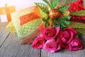 Selective focus and shallow depth of field of a beautiful bouquet of red roses with ribbon on old wooden board background with sun Royalty Free Stock Photo