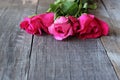 Selective focus and shallow depth of field of bouquet of red roses on old wooden board background with copy space for massage. Val Royalty Free Stock Photo