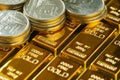 selective focus on shiny gold bars with stack of coins as business or financial investment and wealth concept
