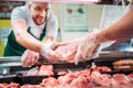selective focus of shop assistants assorting raw meat