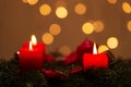 Selective focus shot of an advent wreath decoration with lighted red candles. perfect for wallpaper Royalty Free Stock Photo