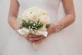 Selective focus shot of a beautiful bride holding a bouquet Royalty Free Stock Photo