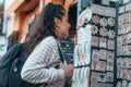 Selective focus shot of a beautiful girl looking at the souvenirs in the street on a sunny day Royalty Free Stock Photo