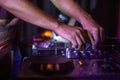 Selective focus shot of black DJ controller with hands of DJ Royalty Free Stock Photo