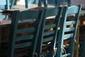 Selective focus shot of blue chairs next to a table in an old taverna in Folegandros, Greece Royalty Free Stock Photo