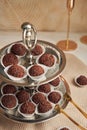 Selective focus shot of Brazilian Brigadeiros served on a two-layer plate, yummy choco balls