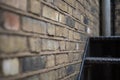 Selective focus shot of a brick wall with a stai