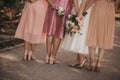 Selective focus shot of the bride and  bridesmaids holding bouquets of beautiful pink roses Royalty Free Stock Photo