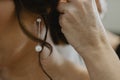 Selective focus shot of a bride wearing elegant earrings