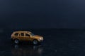 Selective focus shot of a brown toy car on a black surface Royalty Free Stock Photo