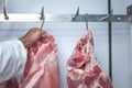 Selective focus shot of the butcher cutting a good piece of pork