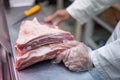 Selective focus shot of the butcher cutting a good piece of pork Royalty Free Stock Photo