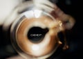 Selective focus shot of the Chemex logo seen through a glass coffee flask