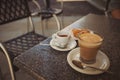 A selective focus shot of coffee with milk and Espresso in a glass cup on the table. Cup of Italian Cappuccino. Royalty Free Stock Photo