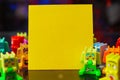 Selective focus shot of colorful interlocking plastic brick toys and a yellow board