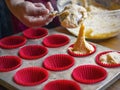 Selective focus shot of a cook putting the raw dough into the baking dish Royalty Free Stock Photo