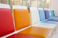 Selective focus shot with copy space of many colorful chairs in a row in the lobby or waiting room in hospital shows joyful, Royalty Free Stock Photo