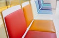 Selective focus shot with copy space of many colorful chairs in a row in the lobby or waiting room in hospital shows joyful, Royalty Free Stock Photo