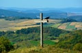 Selective focus shot of a craw perch on a wooden cross on top of a hill Royalty Free Stock Photo