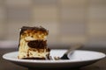 Selective focus shot of a creamy chocolate cake piece and a fork Royalty Free Stock Photo