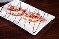 Selective focus shot of delicious and appetizing bruschetta toasts on a wooden table