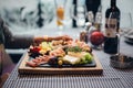 Selective focus shot of delicious meat and cheese platter with wine