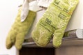 Selective focus shot of dirty green cooking gloves hanging in a kitchen Royalty Free Stock Photo