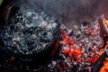 Dutch oven campfire cooking with coal on top Royalty Free Stock Photo