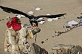 Selective focus shot of an eagle hunter with his golden eagle in Bayan Olgii, West Mongolia