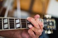 Selective focus shot of an elderly male playing the guitar Royalty Free Stock Photo
