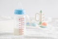 Selective focus shot of a feeding bottle, baby rattle, pacifier and disposable towels Royalty Free Stock Photo