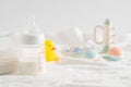 Selective focus shot of a feeding bottle, baby rattle, pacifier, rubber duck and disposable towels Royalty Free Stock Photo