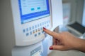 Selective focus shot of a female doctor adjusting the CBC (complete blood count) blood test machine Royalty Free Stock Photo