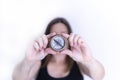 Selective focus shot of female hands holding an old compass Royalty Free Stock Photo