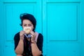 Selective focus shot of a female traveler in a mask holding a donut