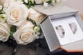 Selective focus shot of flowers and symbolizing wedding rings in a box Royalty Free Stock Photo