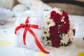 Selective focus shot of flowers and symbolizing wedding rings in a box Royalty Free Stock Photo