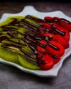 Selective focus shot of fresh kiwi and strawberry decorated with chocolate