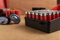 Selective focus shot of a full shotgun ammo box on a brown surface