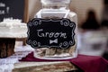 Selective focus shot of a glass jar full of money for the groom Royalty Free Stock Photo